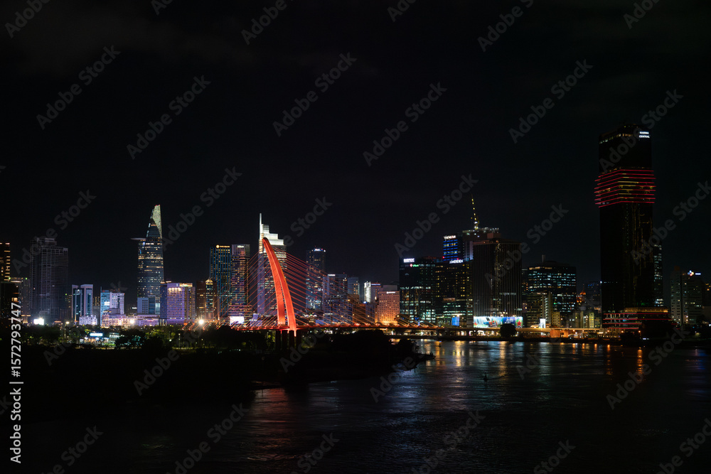 Fototapeta premium Saigon river and the Ho Chi Minh City skyline at night, Vietnam