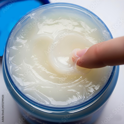 Wallpaper Mural Applying hand using oil petroleum jelly, top view  Torontodigital.ca