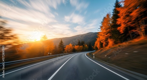 Curvy Road with Golden Trees Driving Into Sunset, Blue Sky