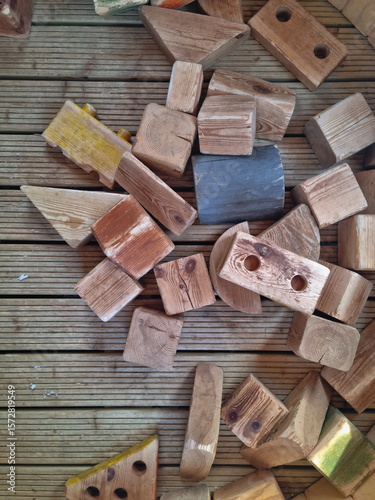 Background with wooden cubes. Chaotically scattered wooden figures. Wooden toys for educational games for children.