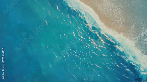 An  of a blue ocean with waves gently washing on the shore, evoking feelings of relaxation and vacation.