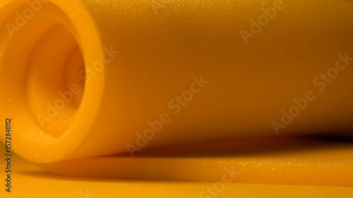 one roll of orange foam sponge. thin material details bundled in a spiral shape