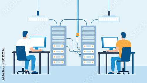 Two people working at computers in a server room with server racks and overhead lighting fixtures present