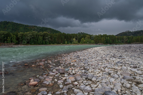 Fast mountain river Katun in Altay, Siberia, Russia. Cloudy skies before the rain