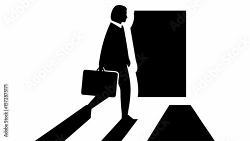 Silhouette of a person walking with a briefcase across a crosswalk into an open doorway in black and white