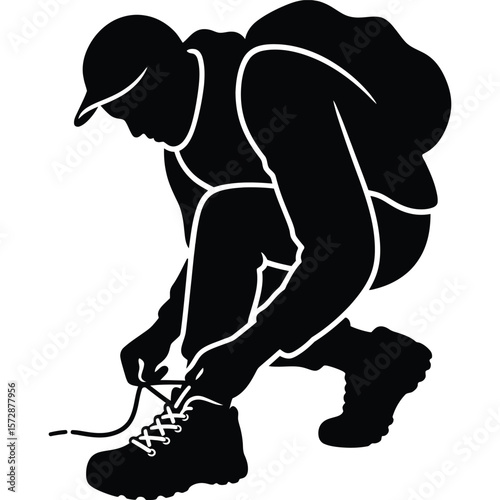 Silhouette of a Hiker Tying Hiking Boots Before Adventure