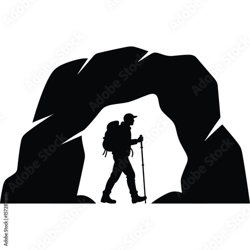 Silhouette of a hiker with a backpack and trekking pole under a rock arch formation in black and white