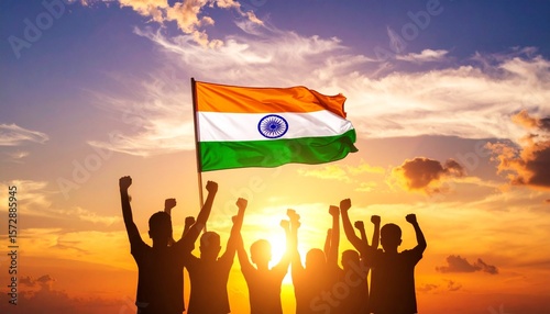 Silhouettes celebrate with the Indian flag against a dramatic sunset sky. This image evokes national pride, unity, and triumph, perfect for themes of freedom, independence, and community spirit.