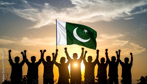 Group of people silhouettes raise fists and Pakistan flag against a vibrant sunset sky, symbolizing national pride, independence, and unity. Celebrate freedom and strength.
