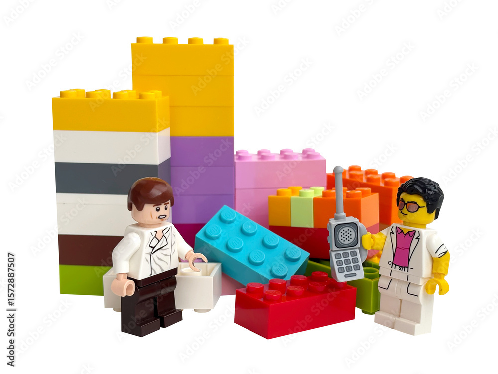 Naklejka premium Two Lego minifigures on the background of Lego bricks on a white background