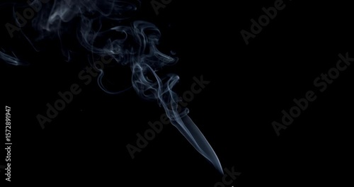 Real smoke on a black background. Thin Flexible Trickle of Real Smoke. Colorful real smoke rises up. Ideal for background or over-layer with blending mode add, screen, lighten.