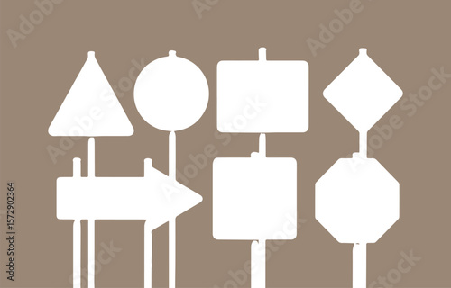 Collection of diverse white blank road signs and traffic symbols on a muted brown background