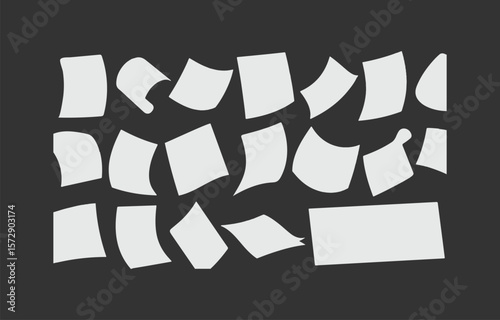 Scattered white paper sheets with different curves and shapes on a dark gray background