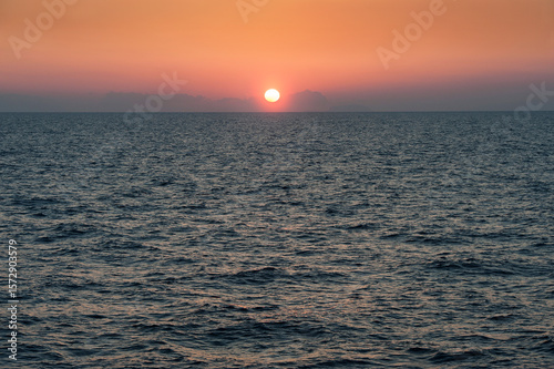 Sun rising over rippled Atlantic ocean