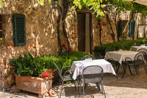 Sunny And Shady Tables At An Idyllic Restaurant