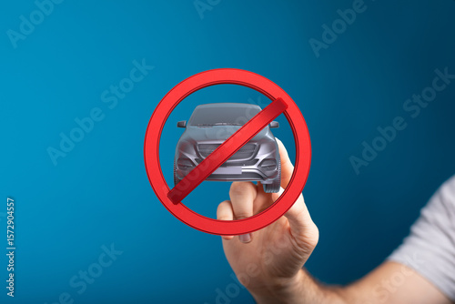 Hand holding a no car sign....