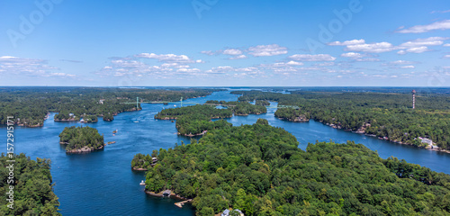 Aerial view of the Saint Lawrence River, Thousand Islands Bridge and 1000 Islands Tower, capturing lush green islands, blue water, and the Canada–US international border on summer day (July 2021)