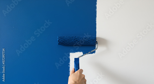 Wall painting with blue paint roller