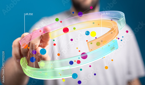 Stock photo of a person interacting with a 3D data visualization. Colorful nodes and connections represent data points.
