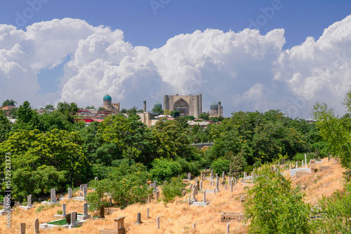 Cemetery near Shah-i-Zinda which is a necropolis in the north-eastern part of Samarkand and Bibi-Khanym Mosque in the background  Samarkand, Uzbekistan