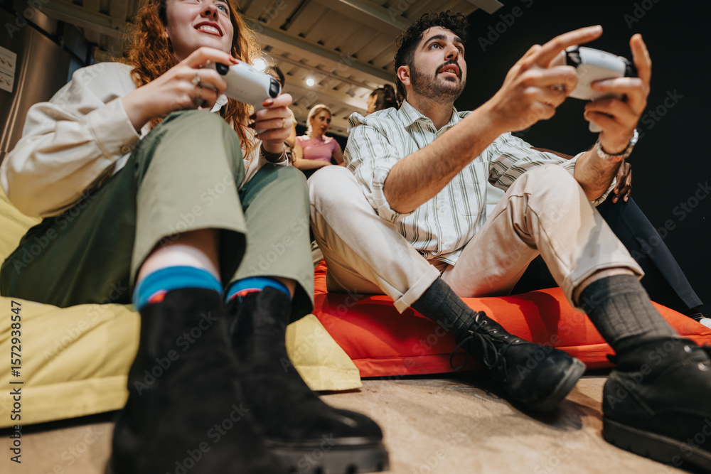 Fototapeta premium Two individuals are seen immersed in a video game activity, showcasing teamwork and enjoyment, while seated in a modern and comfortable gaming environment indoors.