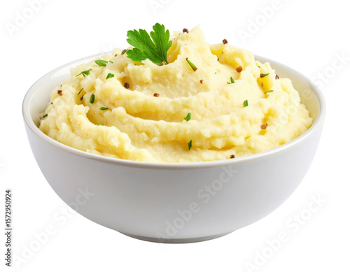 Creamy mashed potatoes garnished with herbs and a parsley leaf served in a white bowl.