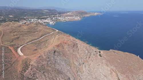 Fly with my drone along the North Crete part of the island with the nature rocks and the crystal clear water and olive tree landscape