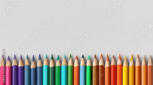 A banner with a simple, clean design, featuring a line of sharpened colored pencils at the bottom edge, leaving a large white space for text. 