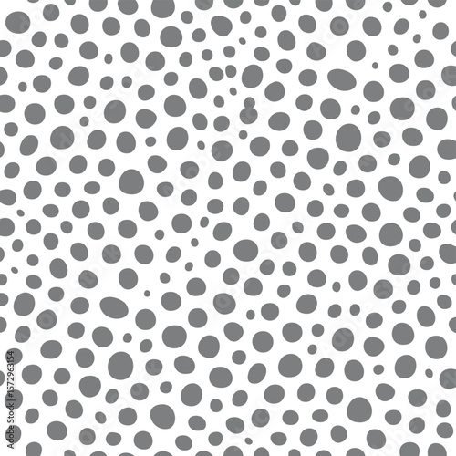 Seamless pattern of scattered grey dots on white background circles irregular