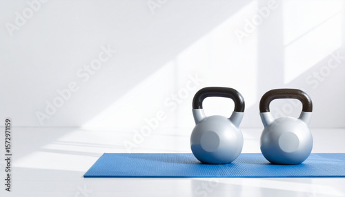 Wallpaper Mural Bright clean workout space with two kettlebell weights on blue exercise mat in natural light Torontodigital.ca