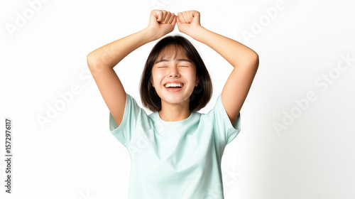 Happy Young Woman Celebrating with Raised Arms Against White Background in Light Mint T-Shirt