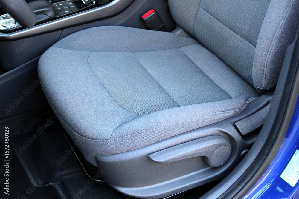 Obraz premium Close-up of light grey power seat. Fabric Ergonomic Premium driver Car Seat. Premium car light grey interior. Interior of prestige electric car. Close up grey textile car seat.