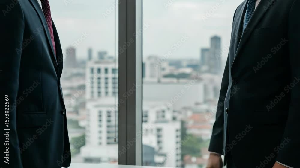 Two businessmen shake hands in front of a panoramic city view, symbolizing a successful business deal Two businessmen shake hands in front of a panoramic city view, symbolizing a successful business deal