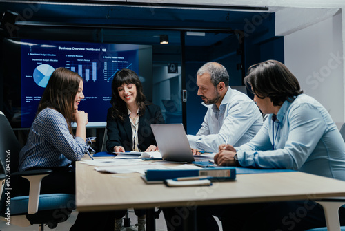 Business executives and assistants brainstorming investment risk evaluation in corporate boardroom