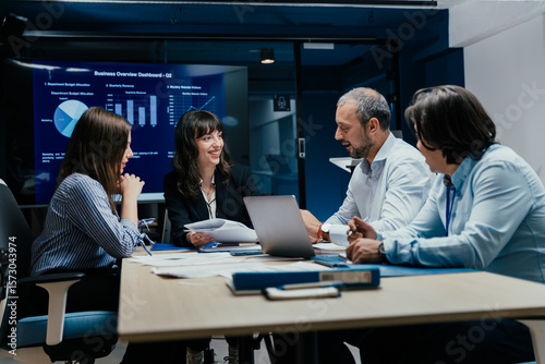 Business executives and assistants brainstorming investment risk evaluation in corporate boardroom