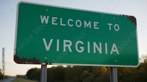 Rustic roadside welcome sign marking the entrance to the state of Virginia during golden hour