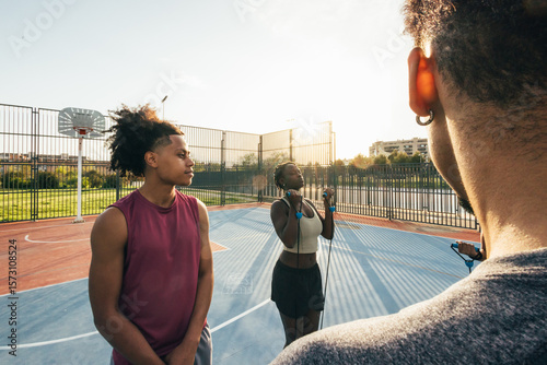 Young athletes training on outdoor basketball court