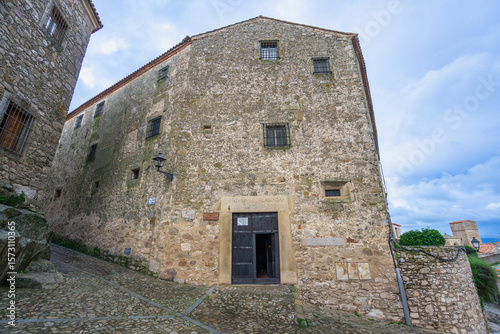 Fototapeta Naklejka Na Ścianę i Meble -  Admire the historic monastery entrance in Trujillo Spain, featuring a stone archway and small windows used for unique money exchange.