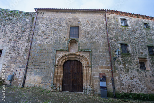 Fototapeta Naklejka Na Ścianę i Meble -  Admire the historic monastery entrance in Trujillo Spain, featuring a stone archway and small windows used for unique money exchange.