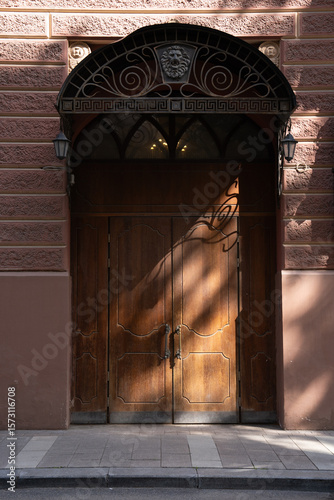 A beautifully crafted Elegant Wooden Door adorned with Exquisite Intricate Ironwork detailing