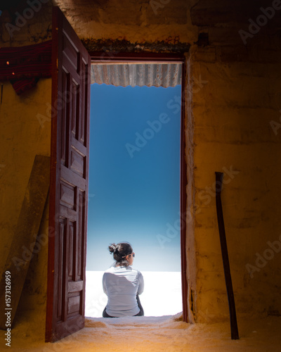 young woman standing in doorway
