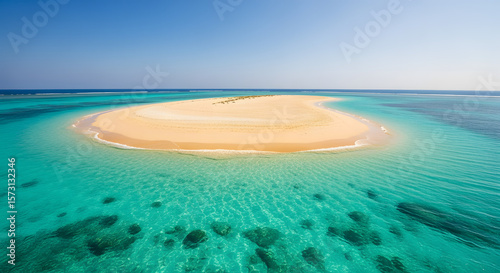 Tiny sandbar in turquoise sea