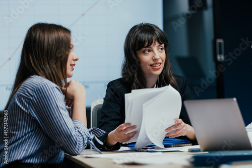 Φωτογραφία Female colleagues listening attentively to opinion during business meeting in of