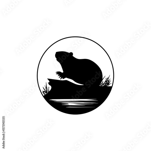 Silhouette of a beaver sitting atop a rock near water enclosed within a circular border design element