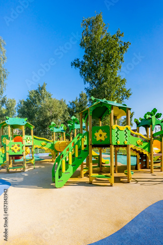 Wallpaper Mural Playground with a yellow fence and green play structures Torontodigital.ca