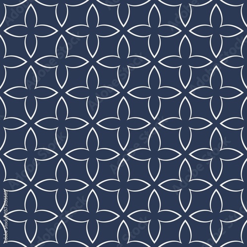 Intricate floral patterns are arranged in a repetitive grid over a dark background, creating a symmetrical and harmonious design. The delicate lines and curves form a captivating visual rhythm.