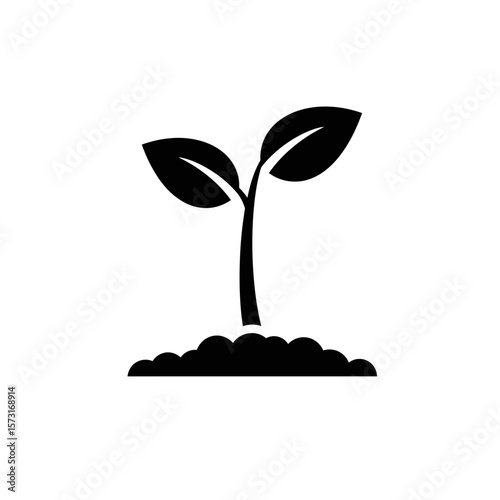 Silhouette of a plant growing from a mound of soil