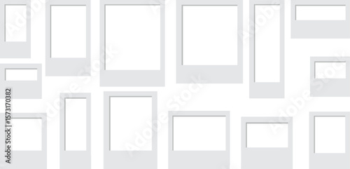 Flat lay of blank photo frames scattered on a white background