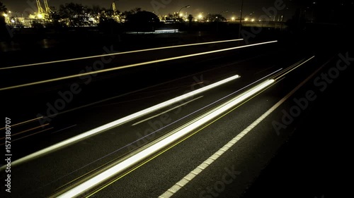 Nighttime time-lapse of car lights on a curved roadway
