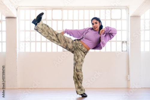 Hip-hop female dancer wearing colorful urban streetwear dancing